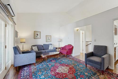 a living room with a couch and two chairs and a rug at Bay View Dog-Friendly Townhouse w/Porch, Gas Grill, Washer/Dryer, Partial A/C in Bar Harbor