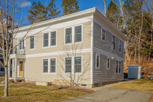 a white and gray house with at Waterfront, walkable, updated home with harbor views & partial AC in Camden