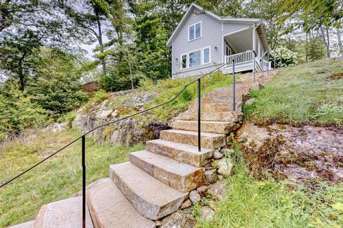a set of stairs leading up to a house at Periwinkle Cottage | Sunny cottage in Westport Island overlooking the river in Westport