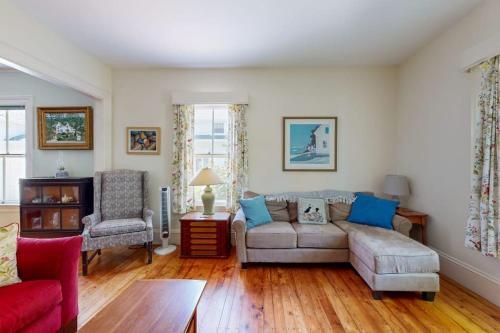a living room with a couch and a chair at Parker House: Historic home - walk downtown, dog-friendly & washer/dryer in Camden