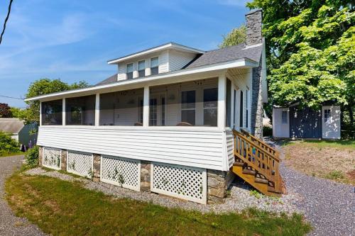 a large white house with a porch and a staircase at Coastal charmer with screened-in porch, grill, & AC in Boothbay Harbor