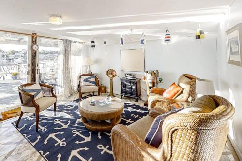 a living room with a couch and chairs and a table at Multi-unit with oar & boat house with private dock & kayaks in Boothbay Harbor