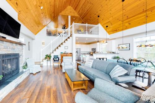 a living room with a couch and a fireplace at Secluded hilltop home with beautiful Cadillac Mountain view and multiple decks in Bar Harbor
