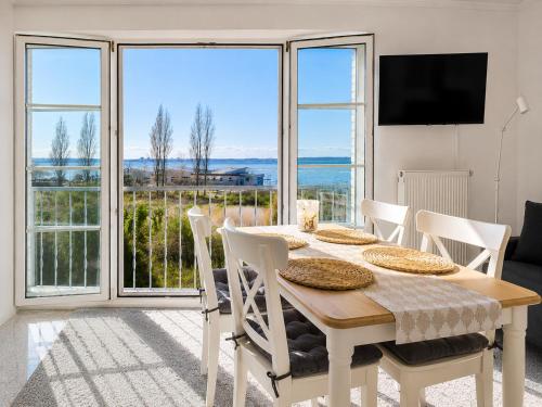 a dining room with a table and views of the ocean at Kiek ut in Stein