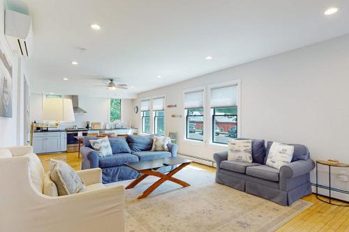 a living room with two couches and a table at Waterfront, walkable home with beautiful kitchen & washer/dryer - dog-friendly in Camden