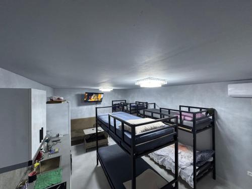 a room with two bunk beds in it at Palma Hostel in Batumi