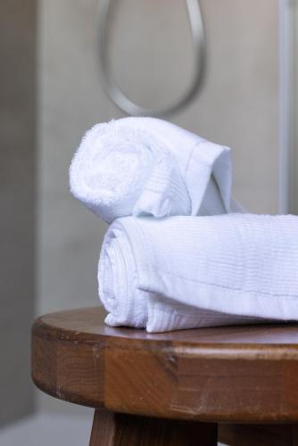 a stack of towels sitting on a table at Cascina Bella - Piozzo in Piozzo