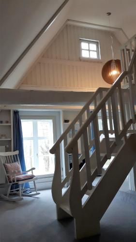 a wooden staircase in a room with a window at Landsitzhotel und Seminarium Peterhof in Hodorf