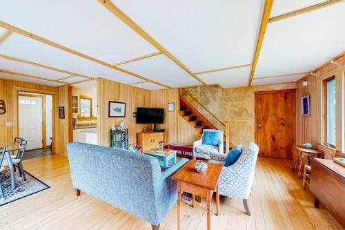 a living room with a couch and a table at Dog-friendly ocean-view home with grill, wood stove, deck, washer/dryer, & AC in Southwest Harbor