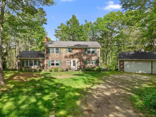 an old brick house with a garage at Tranquil private riverfront home w/ tidal dock & large yard in Boothbay