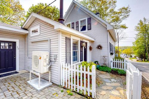 a white house with a white fence in front of it at Classic home with prime location 1 block from Main Street in Bucksport