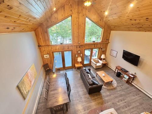 an overhead view of a living room with a large wooden ceiling at Riverfront home w/ deck, amazing views & firepit - near the best of Maine in Stockton Springs