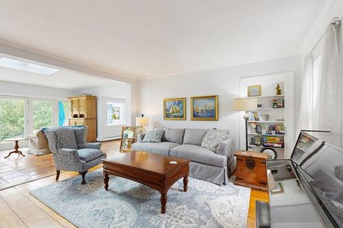 a living room with a couch and a table at Elegant Historic Home with Refined Interiors and Private Outdoor Spaces in Camden