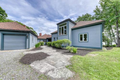 a home with a blue house at Delightful oceanfront home with amazing views, wrap-around deck & two fireplaces in Wiscasset