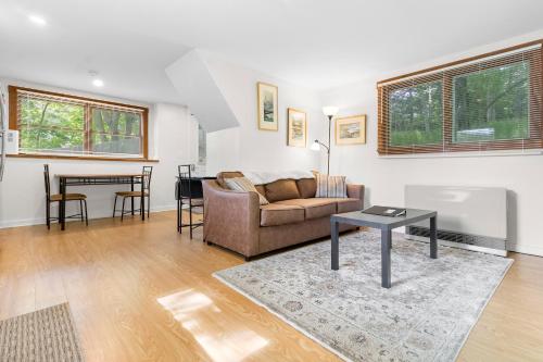 a living room with a couch and a table at Two-Level Unit w/ Patio, Deck, Firepit, Private Washer/ Dryer, and Free WiFi in Seal Harbor
