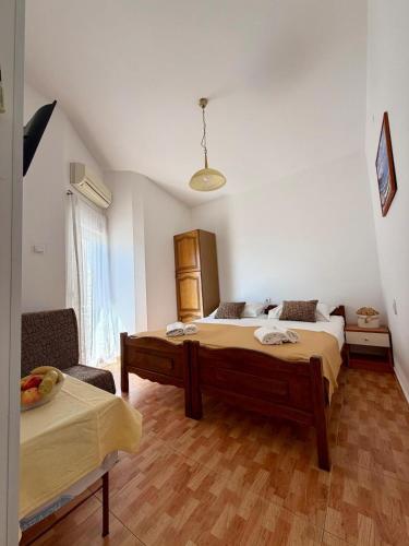 a room with two beds and a couch in it at Studio Apartments Ivo in Baška Voda