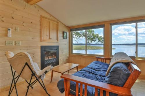 a living room with a couch and a fireplace at Luxe Bayfront Cabin w/ Stunning Views & Shared Dock- Ideal for Hunting & Fishing in Bowdoinham