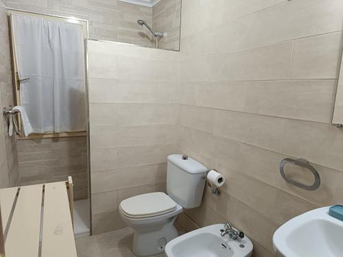 a bathroom with a toilet and a sink and a shower at Casa Montse - Derecha in Colombres