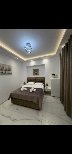 a bedroom with a bed with two towels on it at Aggelos Room 4 in Volos