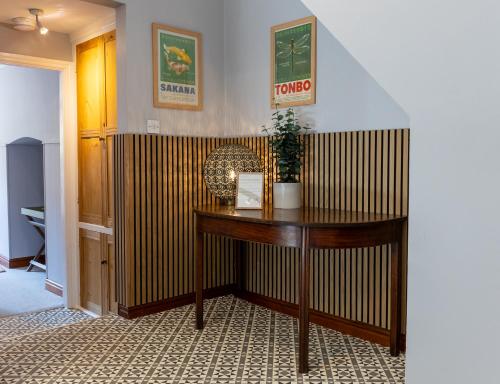 a room with a wooden desk with a plant on it at Spacious One-Bed Apartment in Chester in Chester