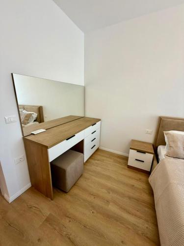 a bedroom with a desk with a bed and a mirror at Golden Space Apartment 3 in Tirana