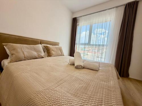 a bedroom with a large bed with a large window at Golden Space Apartment 3 in Tirana