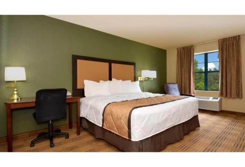 a bedroom with a bed and a desk and a chair at Motel 6 Fairfield OH Cincinnati in Fairfield