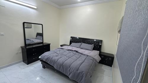 a bedroom with a bed and a mirror at رابغ in Rabigh