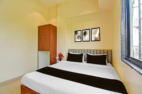 a bedroom with a large bed and a window at Hotel O RVC GRAND CENTRAL in Viman Nagar