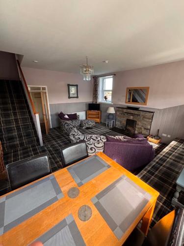 a living room with a table and a couch at Apartment Sleeps 2 with WiFi in Wick