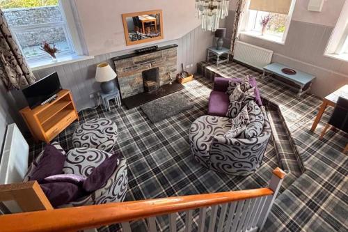 a living room with a couch and a fireplace at Apartment Sleeps 2 with WiFi in Wick
