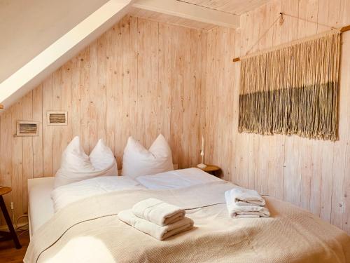 a bedroom with a bed with towels on it at Landhaus Börmoos in Steinberg