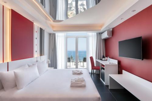 a hotel room with a bed and a television at Vegas Resort in St. Julianʼs
