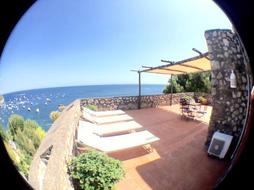 a view of a patio with a view of the ocean at Torre Turbolo Apartments in Massa Lubrense