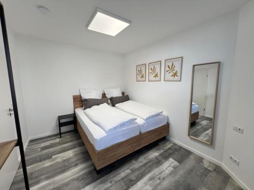 a bedroom with a bed and a mirror at Jagsttalglück in Neudenau