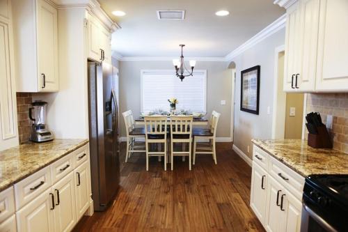 a kitchen with a table and a dining room at Lavish 5 Bedroom, 4 Bath Pool Home 3/4 Mile To Disney in Anaheim