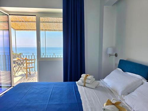 a bedroom with a bed with a view of the ocean at Oasi Relais in Vico Equense
