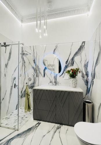 a bathroom with a sink and a mirror at The Gediminas Residence in Vilnius