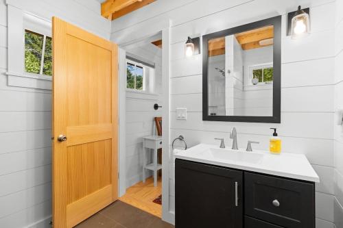 a bathroom with a sink and a mirror at Lindquist Cottage | Waterfront Studio with King Bed in Clark Island