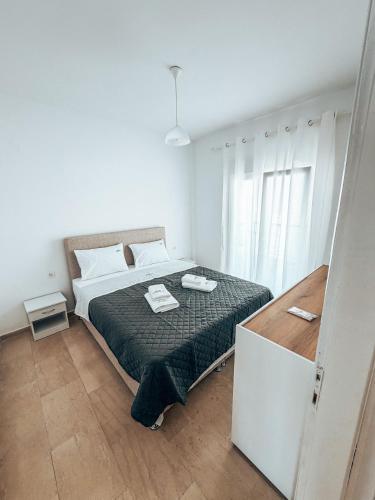 a bedroom with a bed in a white room at Hotel Galini Polychrono in Polychrono