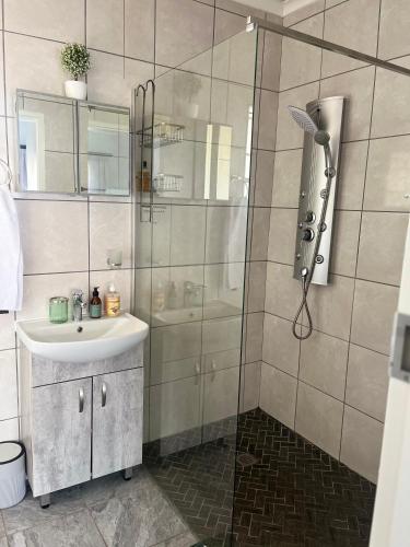a bathroom with a shower and a sink at House 22 on Alice in Centurion