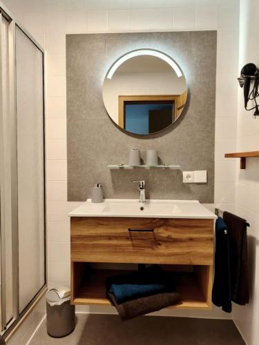 a bathroom with a sink and a mirror at Frühstück Pension by Anna in Rattenberg