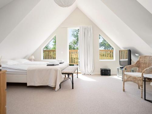 a bedroom with a bed and a table and chairs at 12 person holiday home in BÅSTAD-By Traum in Båstad