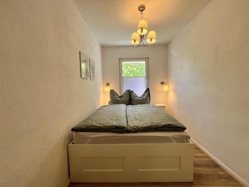 a small bedroom with a bed in the corner at Bungalow Louise in Dobbertin in Dobbertin