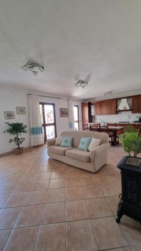 a living room with a couch and a table at Casa Manchia in Loiri