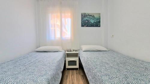 two beds sitting next to each other in a room at Apartamento Fuengirola Costa in Fuengirola