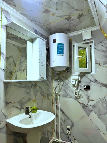 a bathroom with a white sink and a mirror at A-Frame House Tosor in Tossor