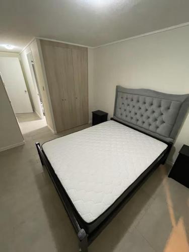 a bed in a room with a white mattress at Comodidad, descanso y disfrute in Algarrobo