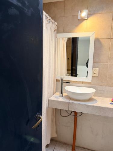 a bathroom with a sink and a mirror on a counter at DUPLEX Parque in Azul