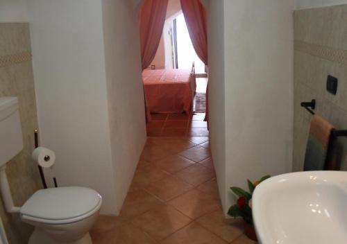 a small bathroom with a toilet and a sink at Trullo Salento in Galatone